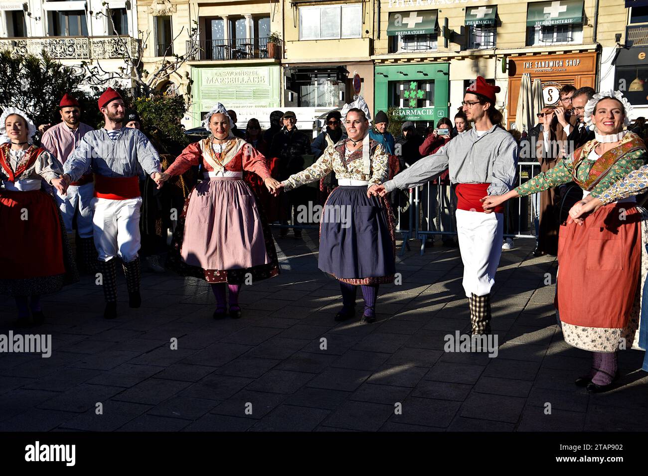 Un gruppo di ballerini popolari in costumi provenzali tradizionali sono visti ballare. Un gruppo di ballerini folcloristici provenzali offre uno spettacolo ai visitatori del Foire aux Santons di Marsiglia. Foto Stock