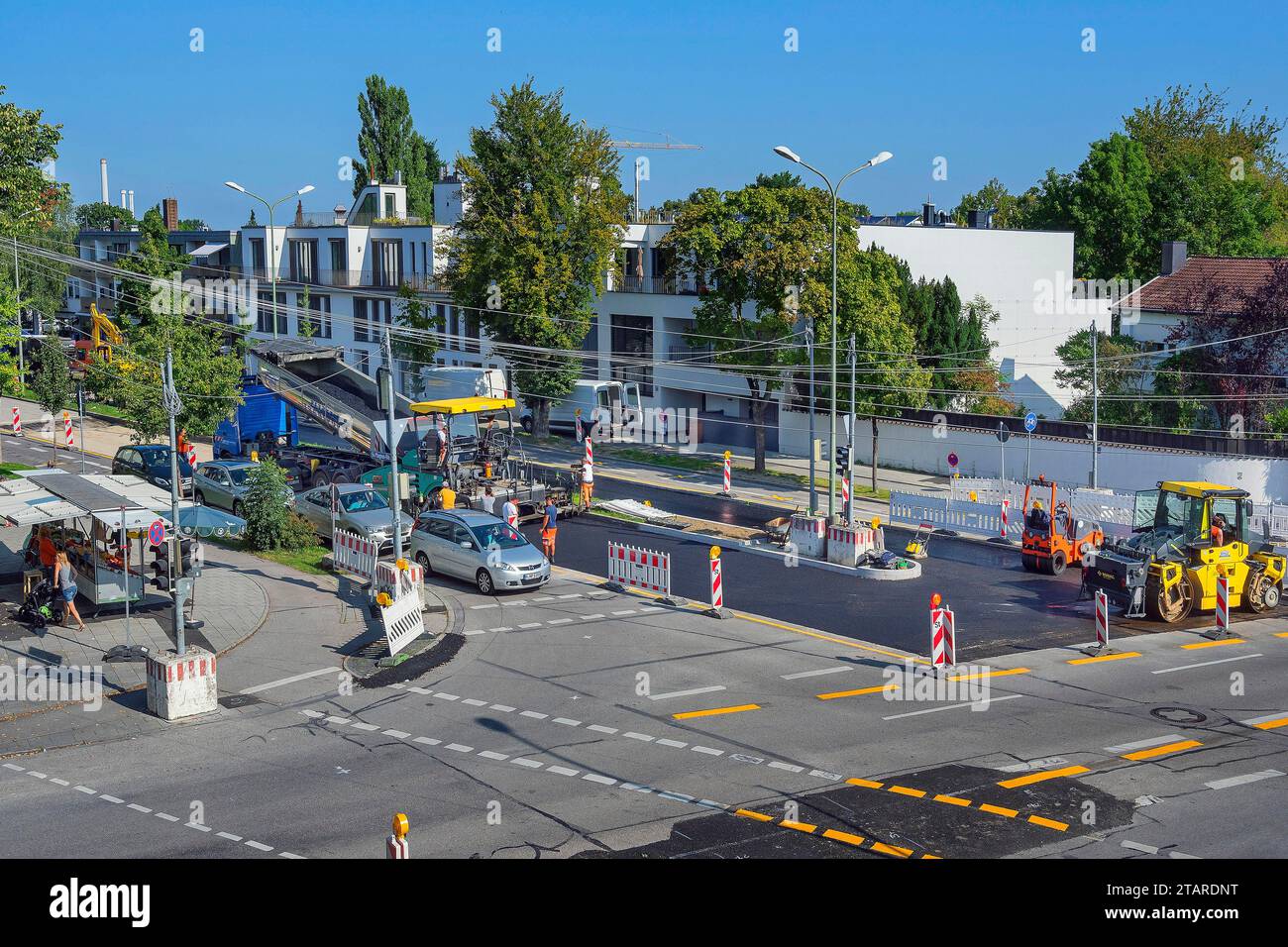 Asfaltatrice, asfaltatrice, lavori di costruzione di strade e nuova costruzione di un sistema a semaforo, Harlaching, Monaco, alta Baviera, Baviera Foto Stock
