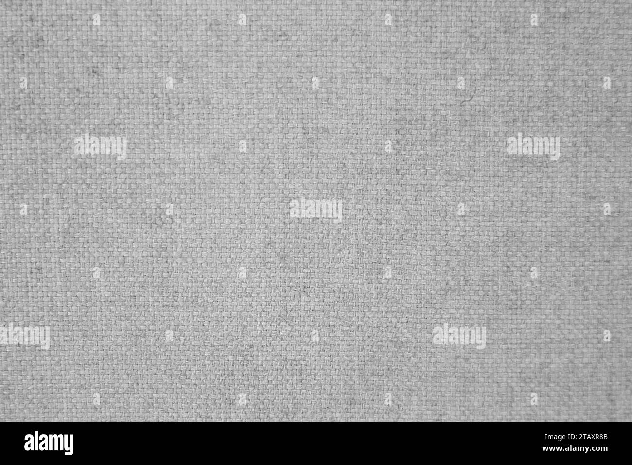 Questa immagine è caratterizzata da un tessuto grigio chiaro che è pesantemente stropicciato e sbiadito Foto Stock