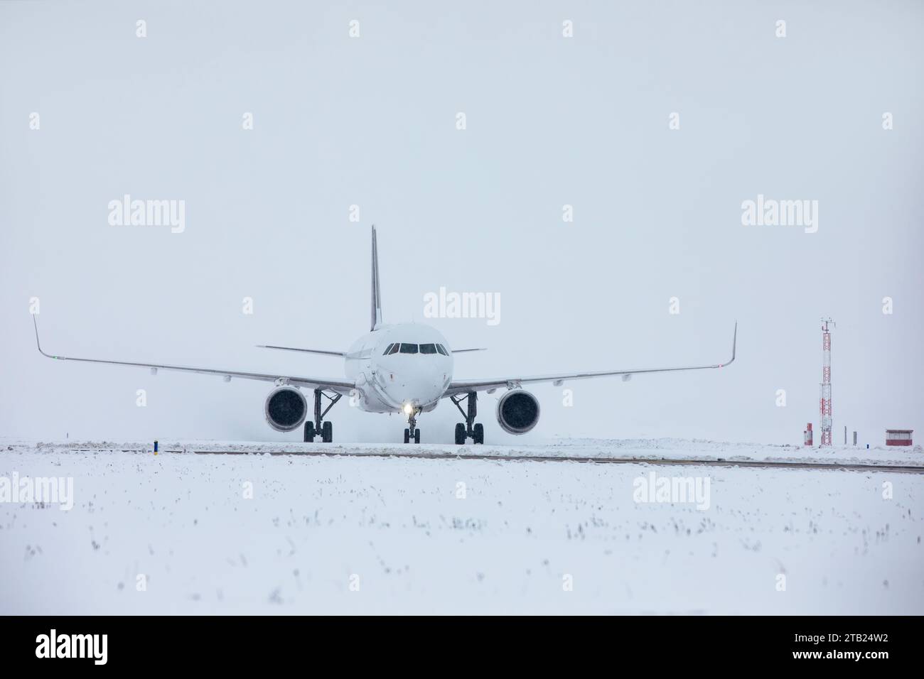 Traffico all'aeroporto durante le nevicate. L'aereo passeggeri rullava sulla pista per decollare in una gelida giornata invernale. Foto Stock