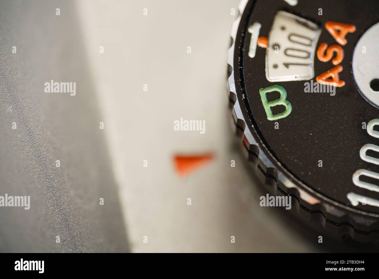 Manopola della velocità dell'otturatore di una vecchia fotocamera per pellicole impostata sulla modalità lampadina, primo piano macro. Foto Stock