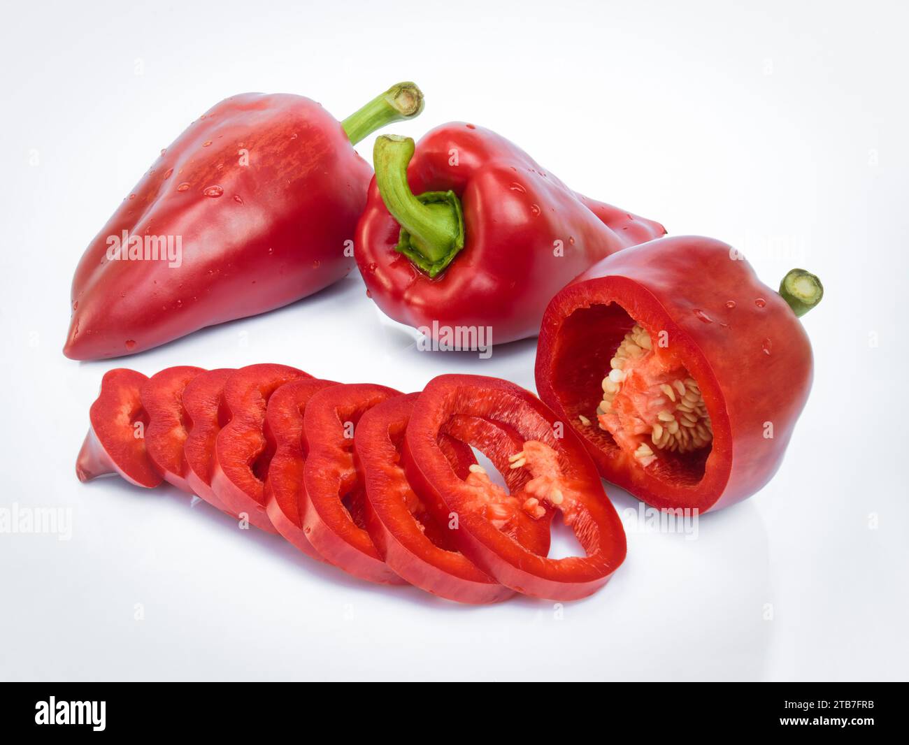 Peperone tagliato a fette ​​red (paprika, capsicum) isolato su fondo bianco con riflesso Foto Stock