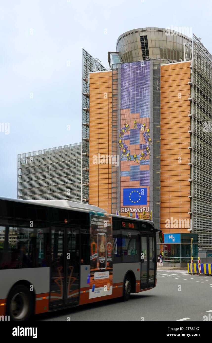 Autobus in movimento di fronte all'edificio della Commissione europea con cartellone pubblicitario Repower EU. Foto Stock