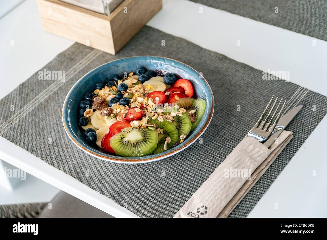 un'immagine di una ciotola di gelato di acai condita con frutta e avena appena tagliate in un ristorante mediterraneo. Foto Stock