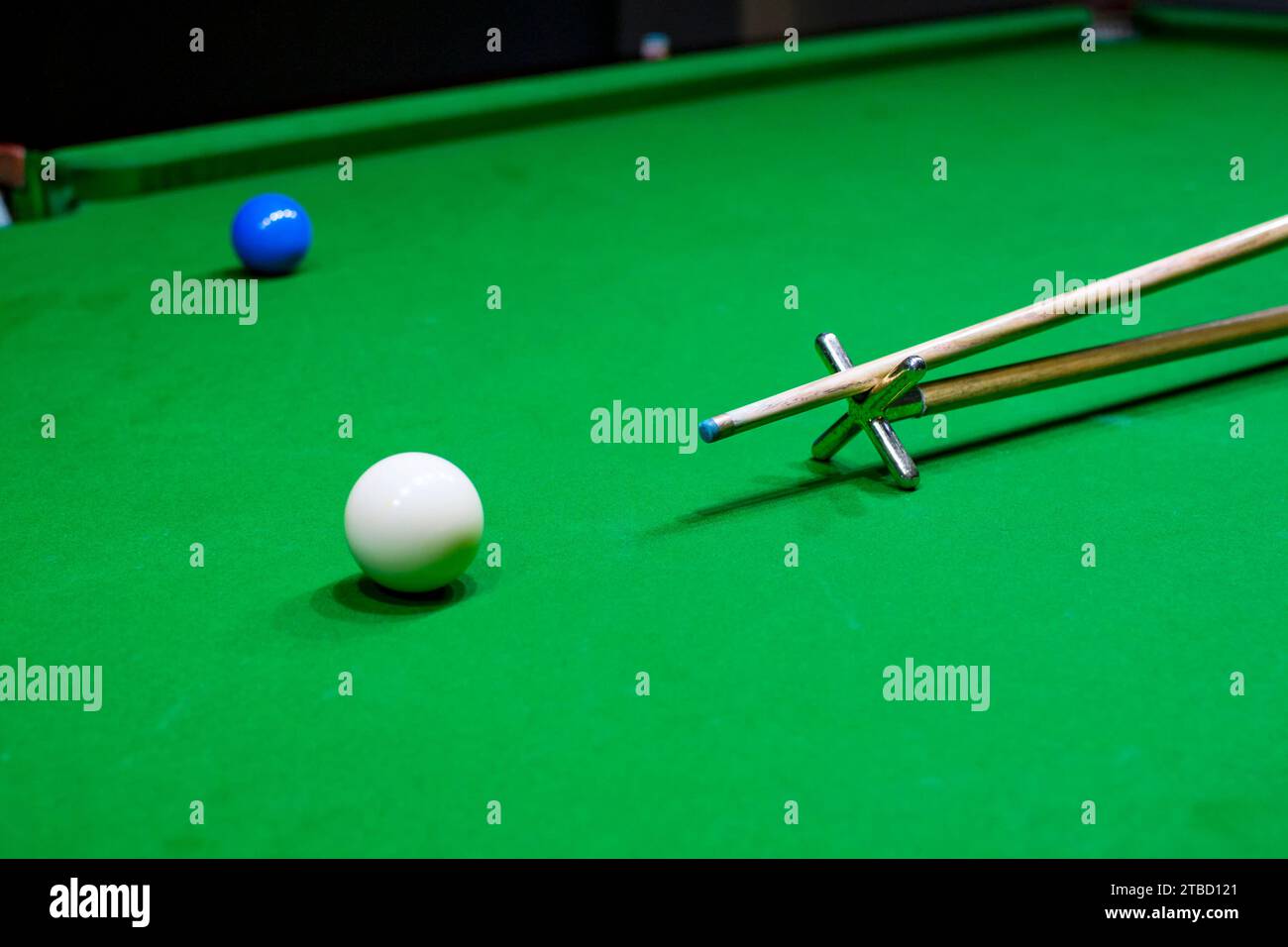 Snooker table. Aiming the cue ball with spider stick. Foto Stock