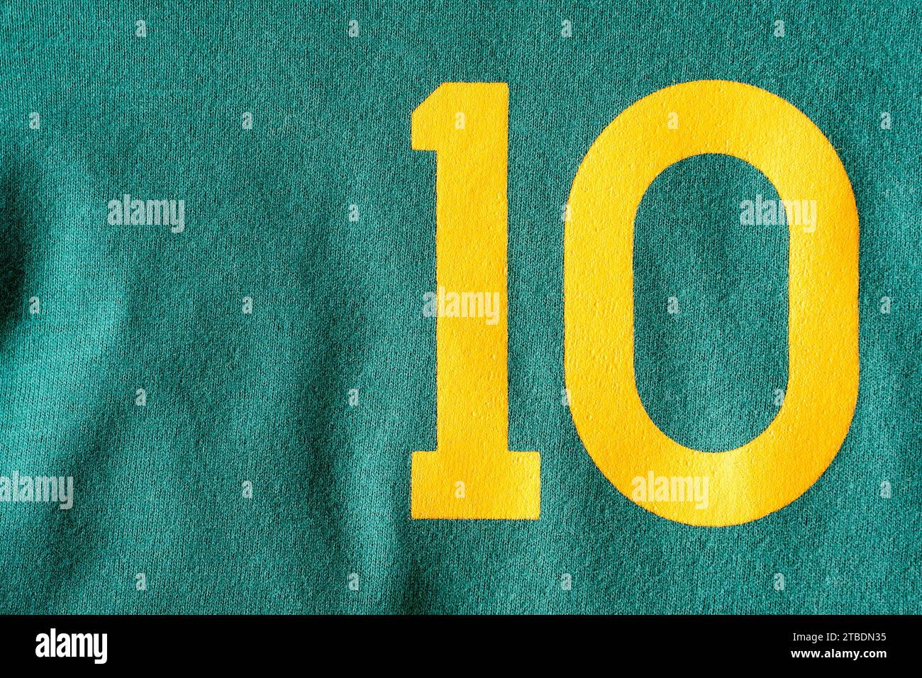 Brasile 10. Numero 10 in giallo dipinto su sfondo di tessuto verde. Colori Brasile. Camicia 10, giocatore di football. Foto Stock