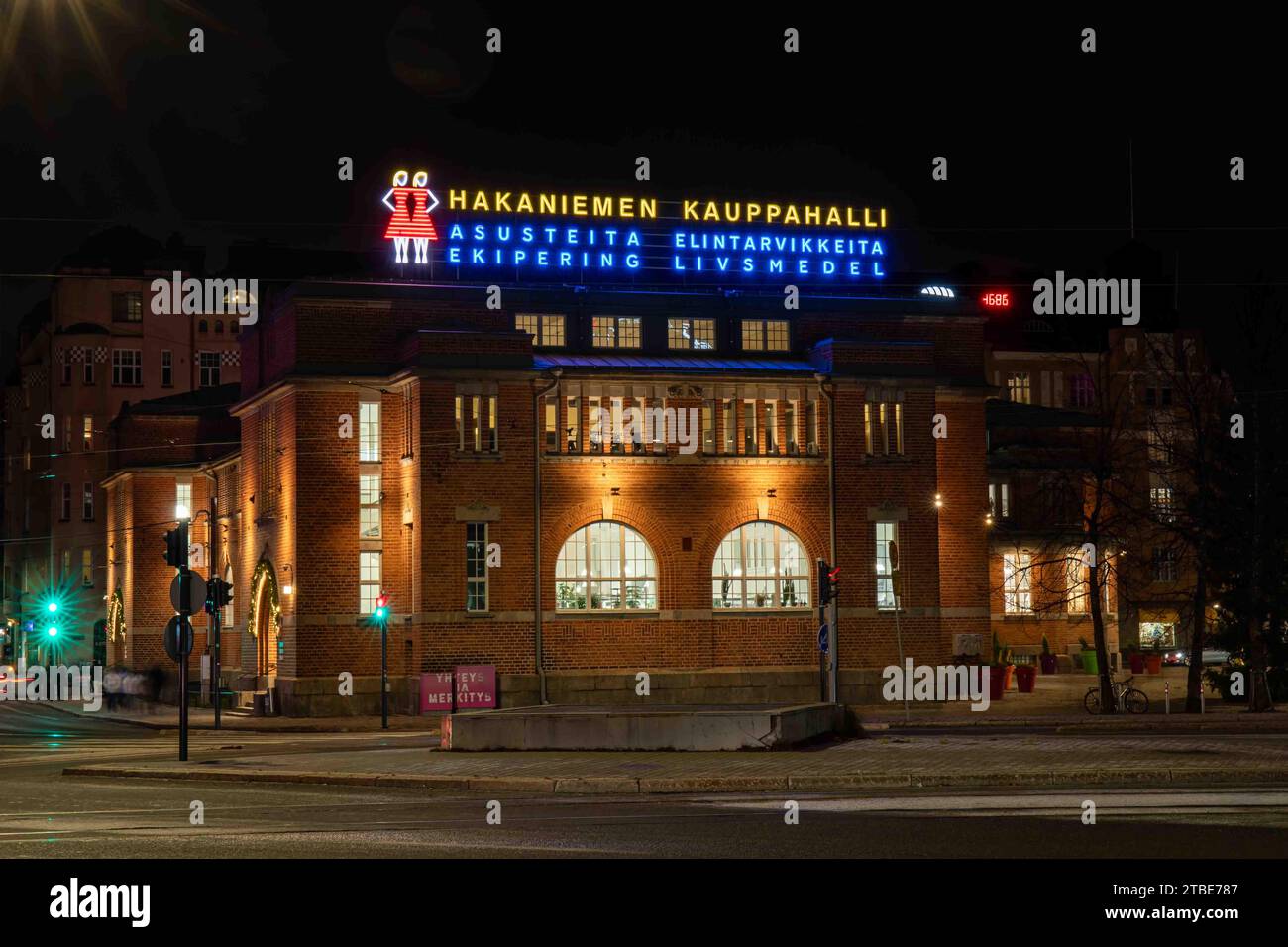 Hakaniemen kauppahalli o Hakaniemi Market Hall con luci al neon dopo il tramonto a Helsinki, Finlandia Foto Stock