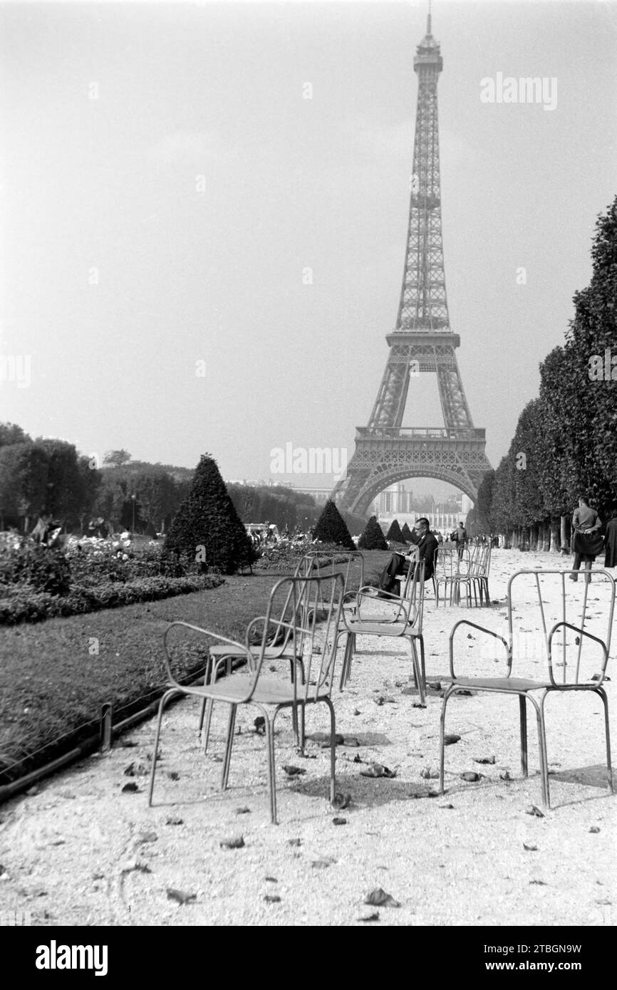 Zeitung lesen im garten des Eiffelturms, Parigi 1962. Leggendo il giornale nel giardino della Torre Eiffel, Parigi 1962. Foto Stock
