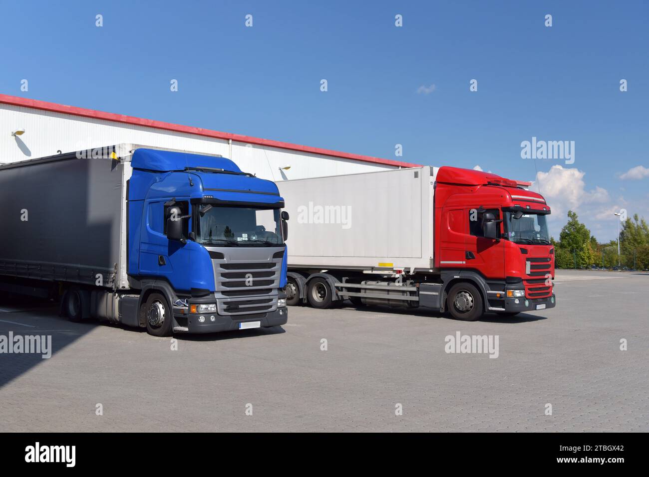 Camion che caricano ad un deposito di un'agenzia di spedizione - Trasporti e logistica nel commercio di merci Foto Stock