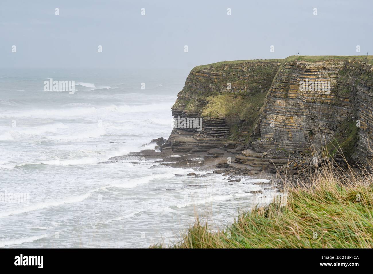 Onde forti che si infrangono sulle scogliere di Galizano in Cantabria Foto Stock