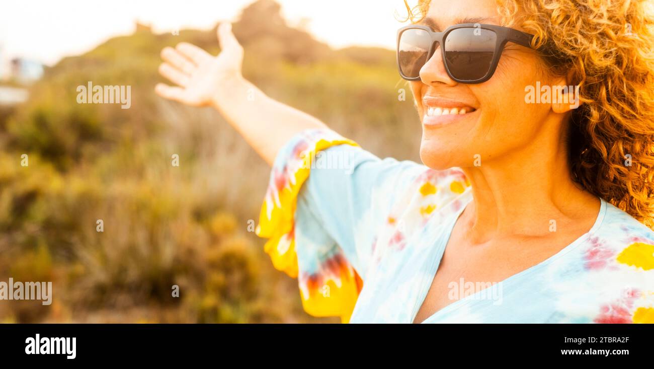 Ritratto di una donna allegra e allegra in attività ricreative all'aperto da sola sorridendo e godendosi la libertà al tramonto. Viaggiate. Stile di vita sano e natura. Adulto femmina persona felice e libera Foto Stock