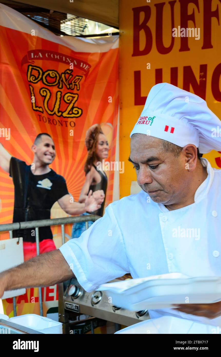 Chef latino-americano che serve cibo su un chiosco durante la salsa su St. Clair Traditional Festival, Toronto, Canada Foto Stock