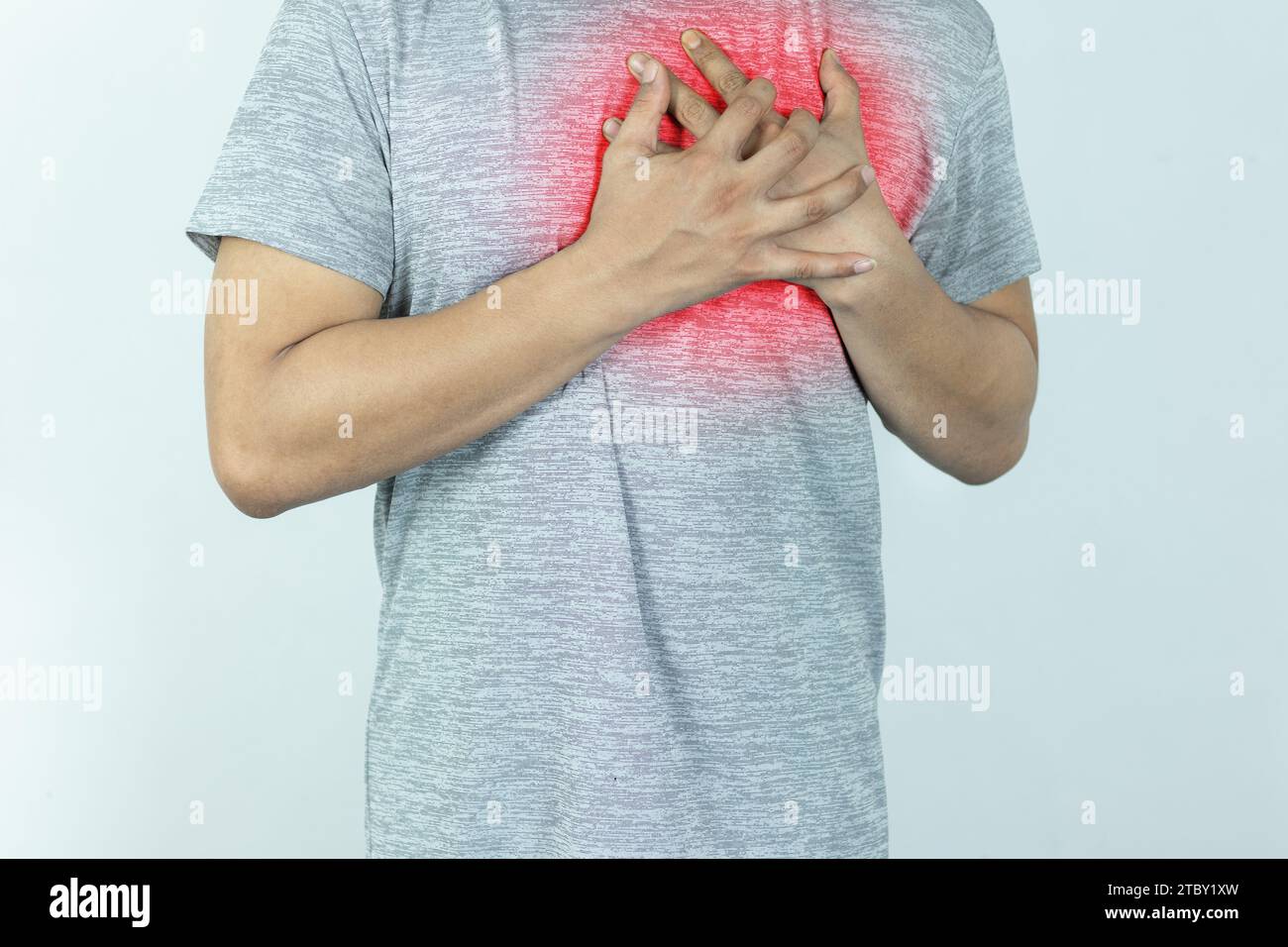 uomo asiatico che preme il petto con espressione dolorosa. Dolore grave, con attacco di cuore o crampi dolorosi, malattie cardiache. Foto Stock