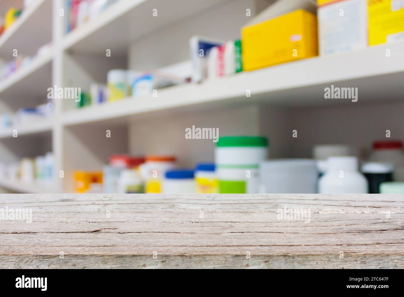 bancone in legno con scaffali di droga sfocati in farmacia Foto Stock