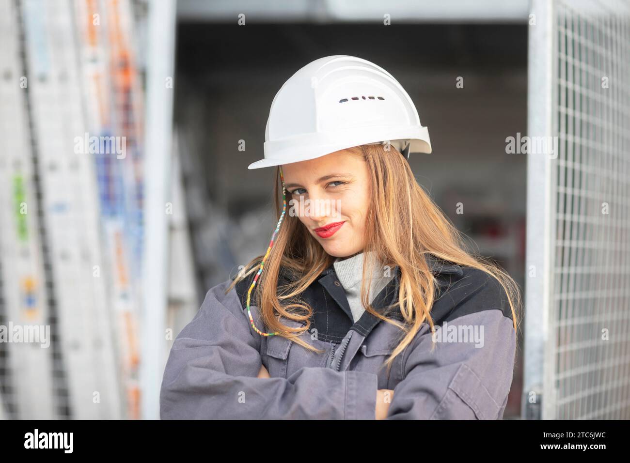 Giovane ingegnere donna con casco che guarda Foto Stock