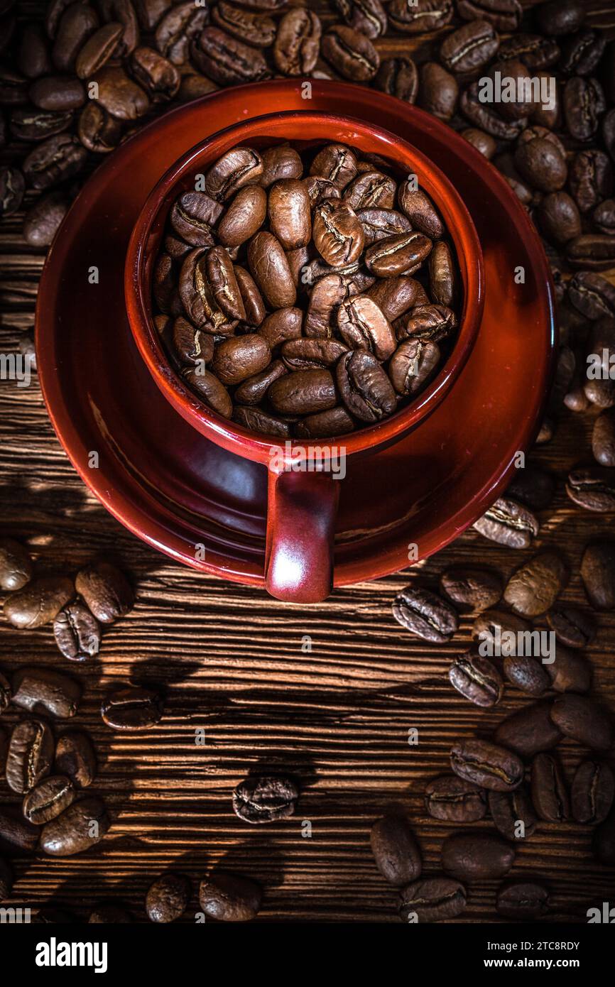 Piatto di tazza di semi di caffè su tavola di legno vintage Foto Stock