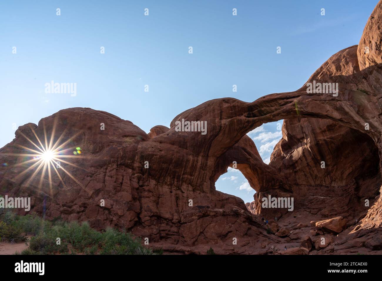 Arco doppio con stella solare al crepuscolo nell'Arches National Park, Utah, Stati Uniti Foto Stock