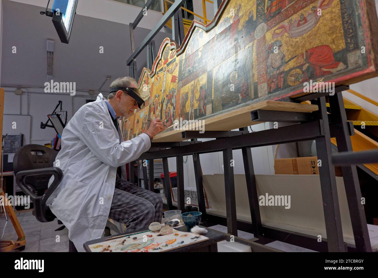 Città del Vaticano, Vaticano. 11 dicembre 2023. Il restauratore Marco Pratelli sta lavorando a un dipinto presso il ''laboratorio di restauro dei materiali di pittura e legno'' all'interno dei Musei Vaticani a città del Vaticano, Vaticano, l'11 dicembre 2023. ''oltre la superficie. Lo sguardo del restauratore'' è l'iniziativa espositiva promossa dai Musei del Papa nell'ambito delle celebrazioni per il centenario del laboratorio per il Restauro dei dipinti e dei materiali lignei dei Musei Vaticani l'11 dicembre 2023. (Foto di massimo Valicchia/NurPhoto)0 crediti: NurPhoto SRL/Alamy Live News Foto Stock