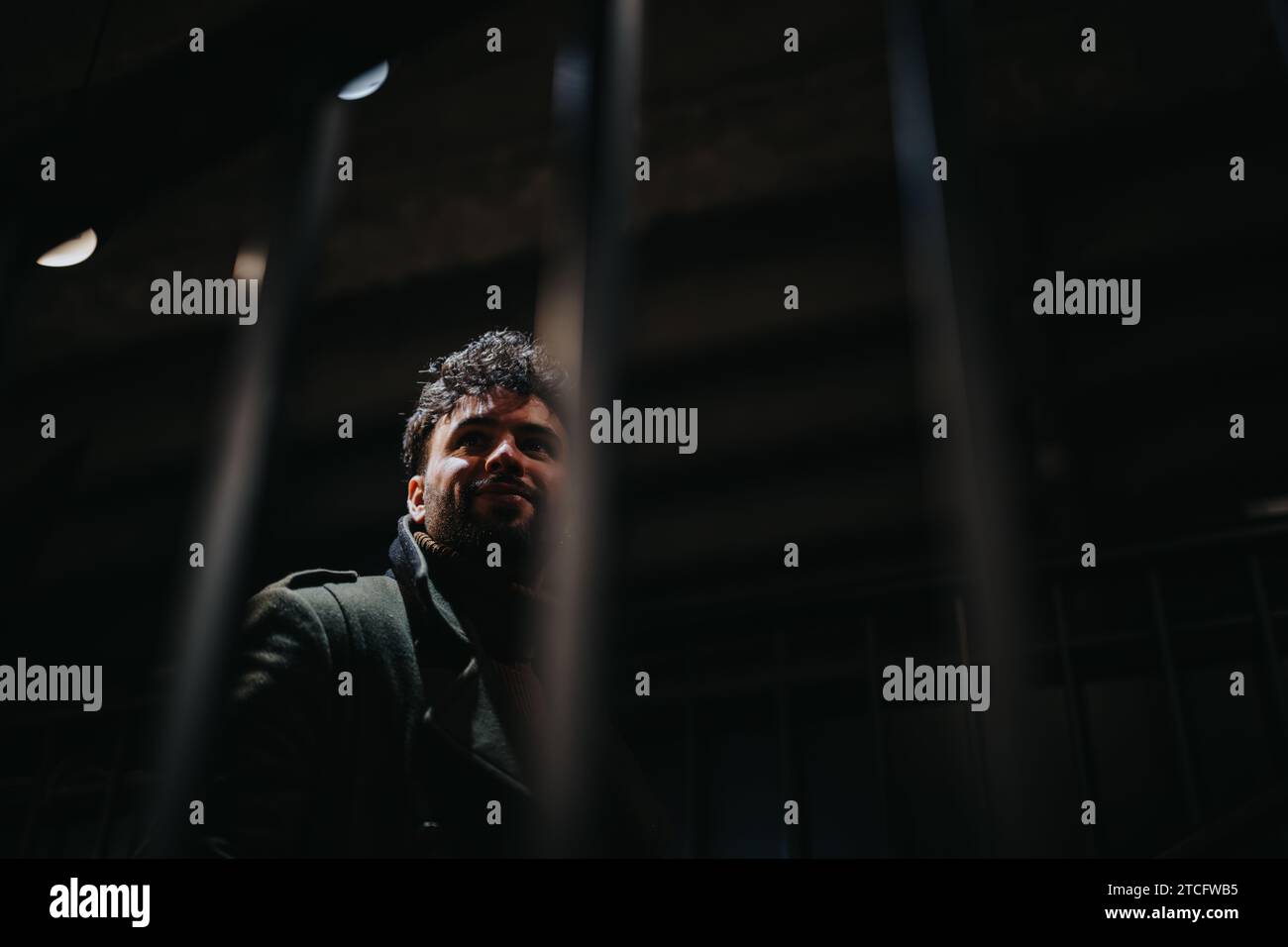 Bell'uomo che va a bere una birra dopo il lavoro. Sta guardando qualcosa con un leggero sorriso in faccia. Foto Stock