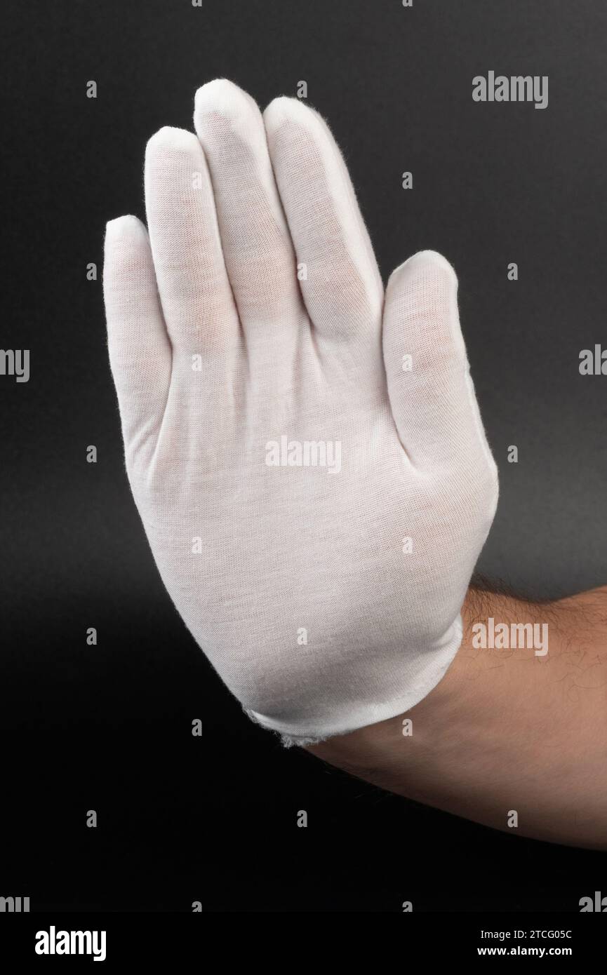 Interrompi lo spettacolo dei gesti con la mano bianca del palmo del guanto per vedere da vicino Foto Stock