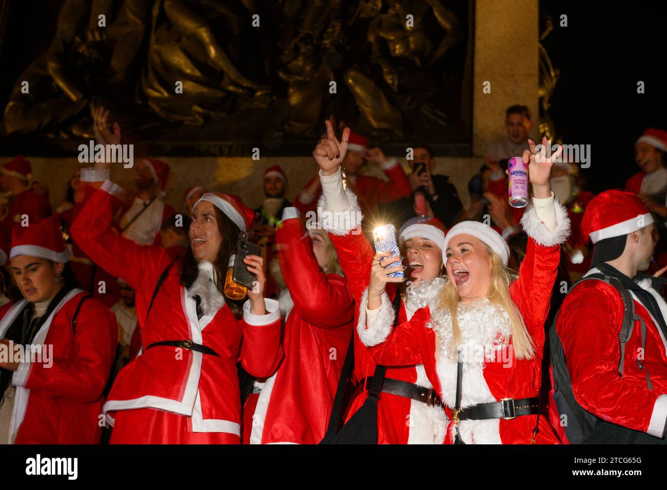 Persone che prendono parte a SantaCon a Trafalgar Square, che prevede di vestirsi da Babbo Natale e poi uscire in città per diffondere l'allegria natalizia. La Foto Stock