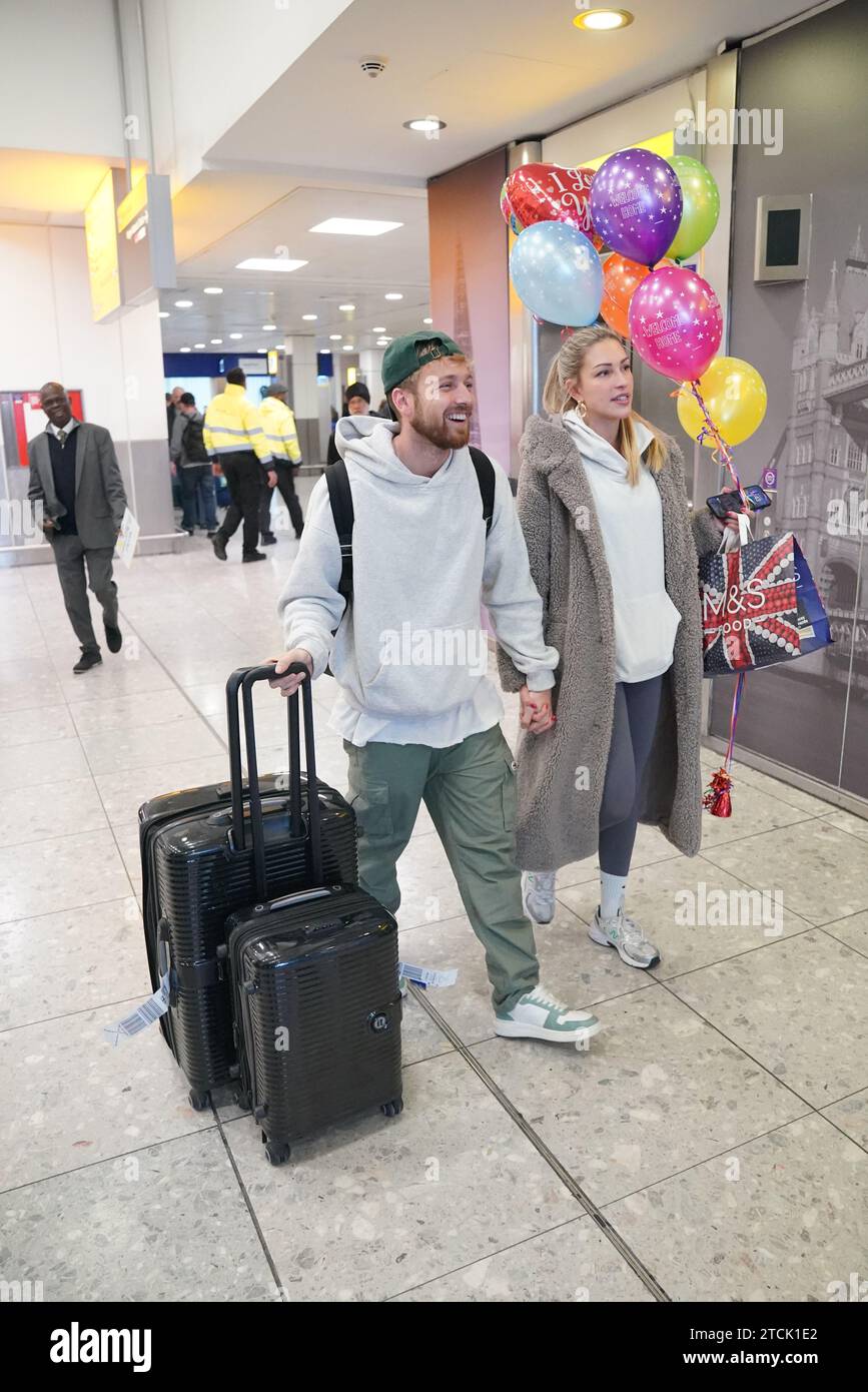Il vincitore della serie Sam Thompson (a sinistra) viene accolto da Zara McDermott all'aeroporto di Heathrow, Londra, dopo aver preso parte alla serie ITV i'm A Celebrity Get me Out of Here! In Australia. Data foto: Mercoledì 13 dicembre 2023. Foto Stock