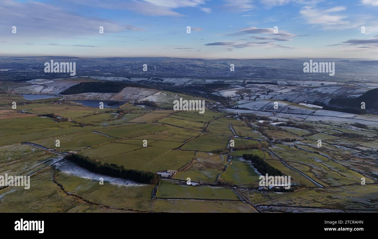 Una vista aerea della campagna presa da un aereo, che mostra il vibrante paesaggio verde sottostante, punteggiato da piccole case e strade tortuose Foto Stock