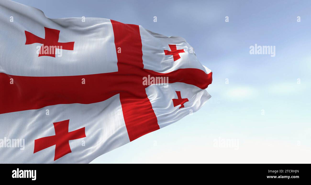 Bandiera nazionale della Georgia che sventola nel vento in una giornata  limpida. Bianco con una croce rossa, quattro croci più piccole in ogni  quadrante. rendering dell'illustrazione 3d. Influenza Foto stock - Alamy