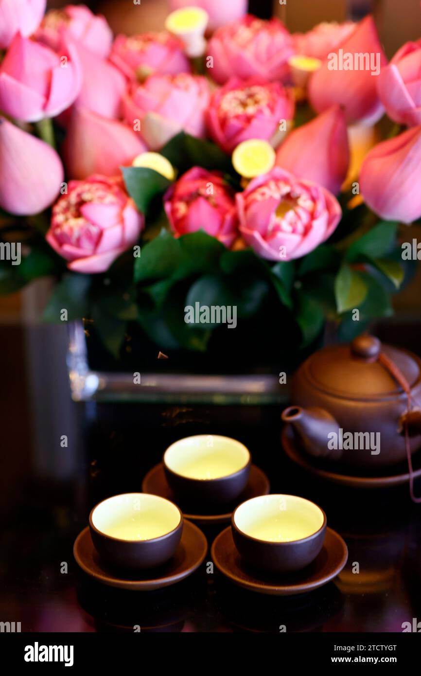 Tre tazze di tè e fiori di loto. Cerimonia del tè. Foto Stock