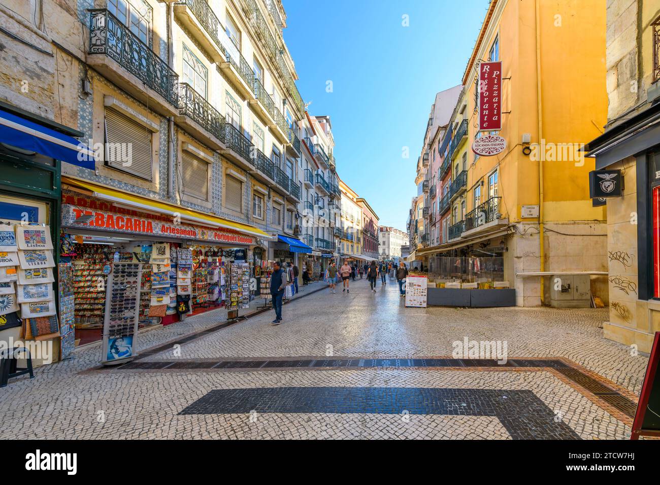 La famosa via Rua Augusta, piena di negozi e ristoranti che si godono i negozi, i ristoranti e i caffè sul marciapiede di Lisbona, Portogallo. Foto Stock