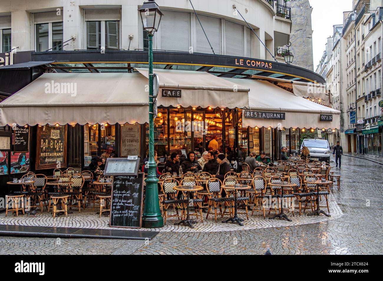 Persone sedute all'aperto sulla terrazza al le Compas, un ristorante francese in Rue Montorgueil, Parigi Foto Stock