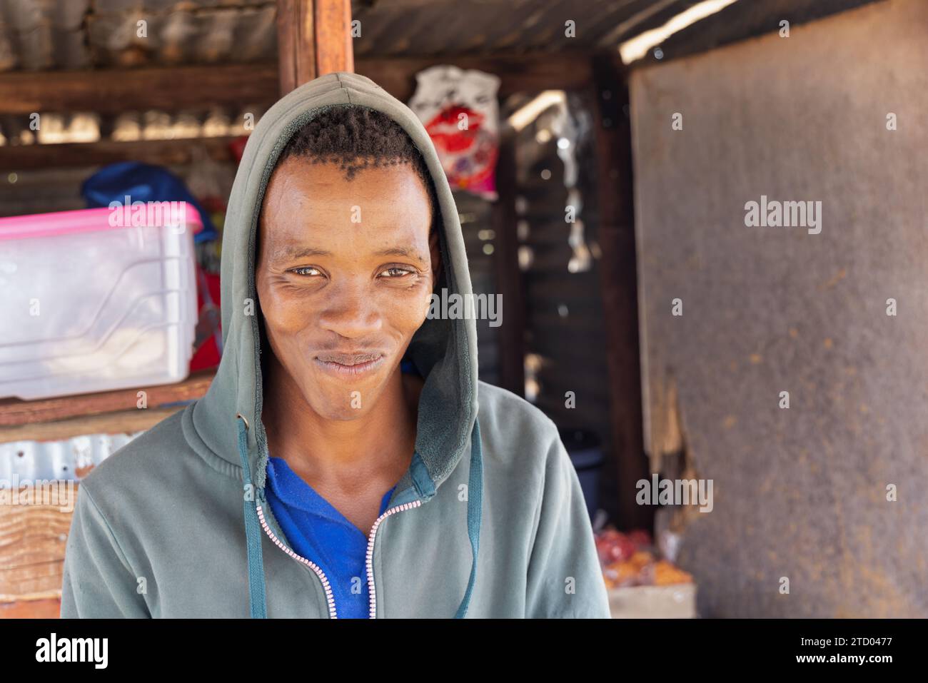 un giovane africano del villaggio in una baracca locale che si prende qualche spuntino Foto Stock