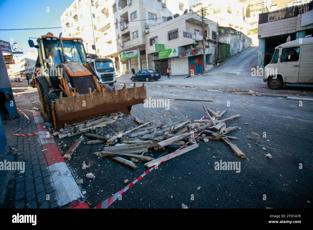 Un bulldozer palestinese rimuove le macerie dal sito di un attacco aereo israeliano contro militanti palestinesi dal campo profughi di Balata, a est della città di Nablus in Cisgiordania. Un drone israeliano ha razziato i militanti palestinesi vicino alla tomba di Giuseppe per un tentativo di assassinarli, e sono fuggiti. Non sono state riportate ferite e il raid ha causato distruzione in strada. (Foto di Nasser Ishtayeh / SOPA Images/Sipa USA) Foto Stock