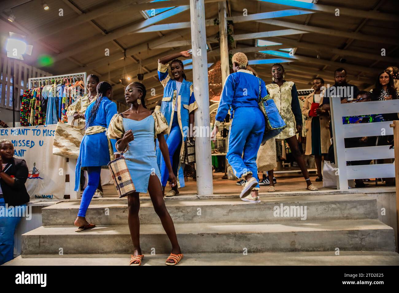 I modelli sfilano lungo la passerella vestita con abiti disegnati da Afrowema in collaborazione con Seeds and Stories from Uganda durante il Just Fashion Day Foto Stock