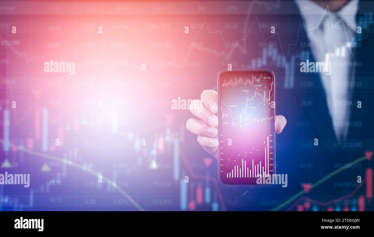 L'uomo d'affari possiede uno smartphone con linea di grafico del mercato azionario o forex e grafico a candelabro adatto per il concetto di investimento finanziario, economia Foto Stock