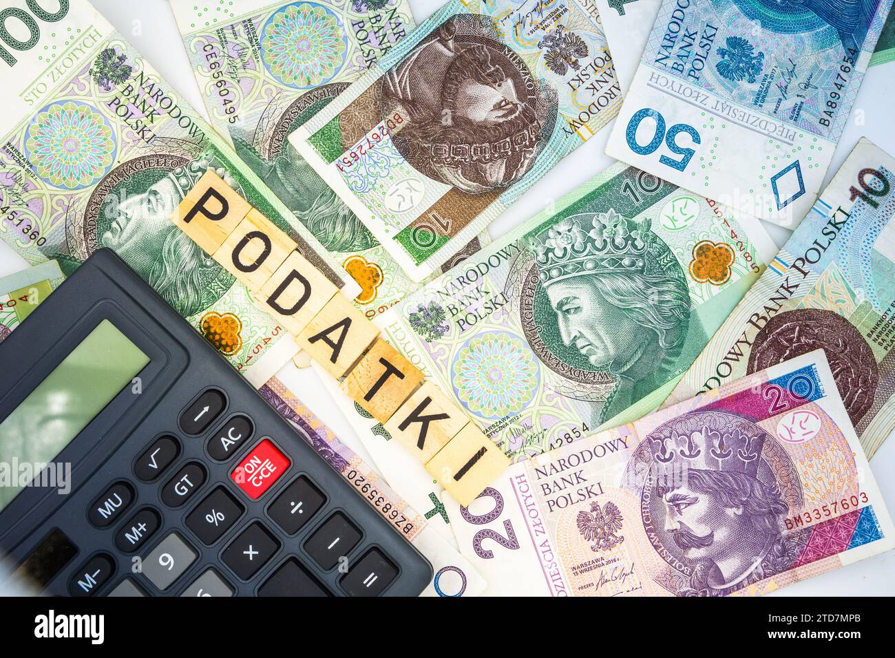 Tassa polacca "Podatki" con calcolatore che contabilizza la valuta polacca di fondo delle banconote in zloty Foto Stock