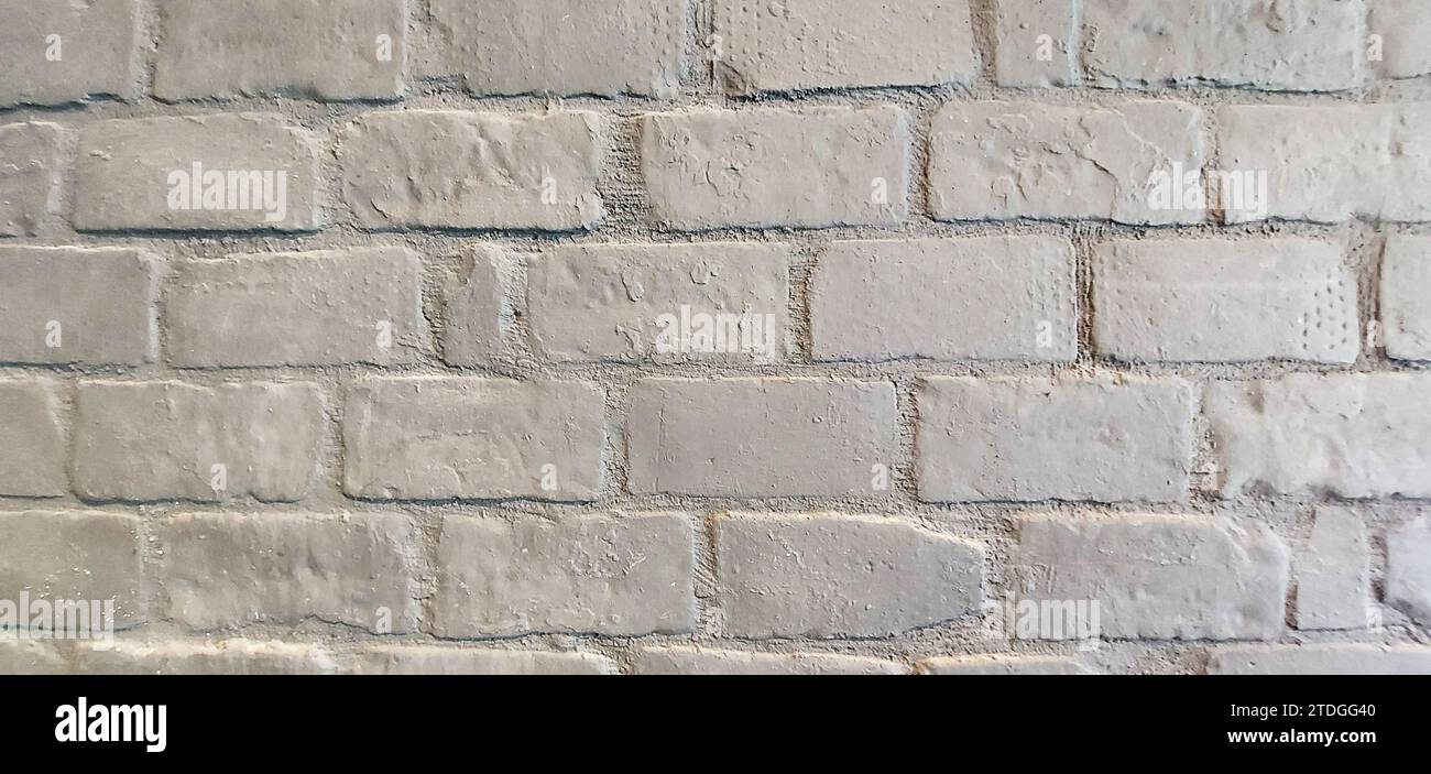 Primo piano dettaglio di una sezione di un muro di mattoni bianchi all'esterno di un edificio. Foto Stock