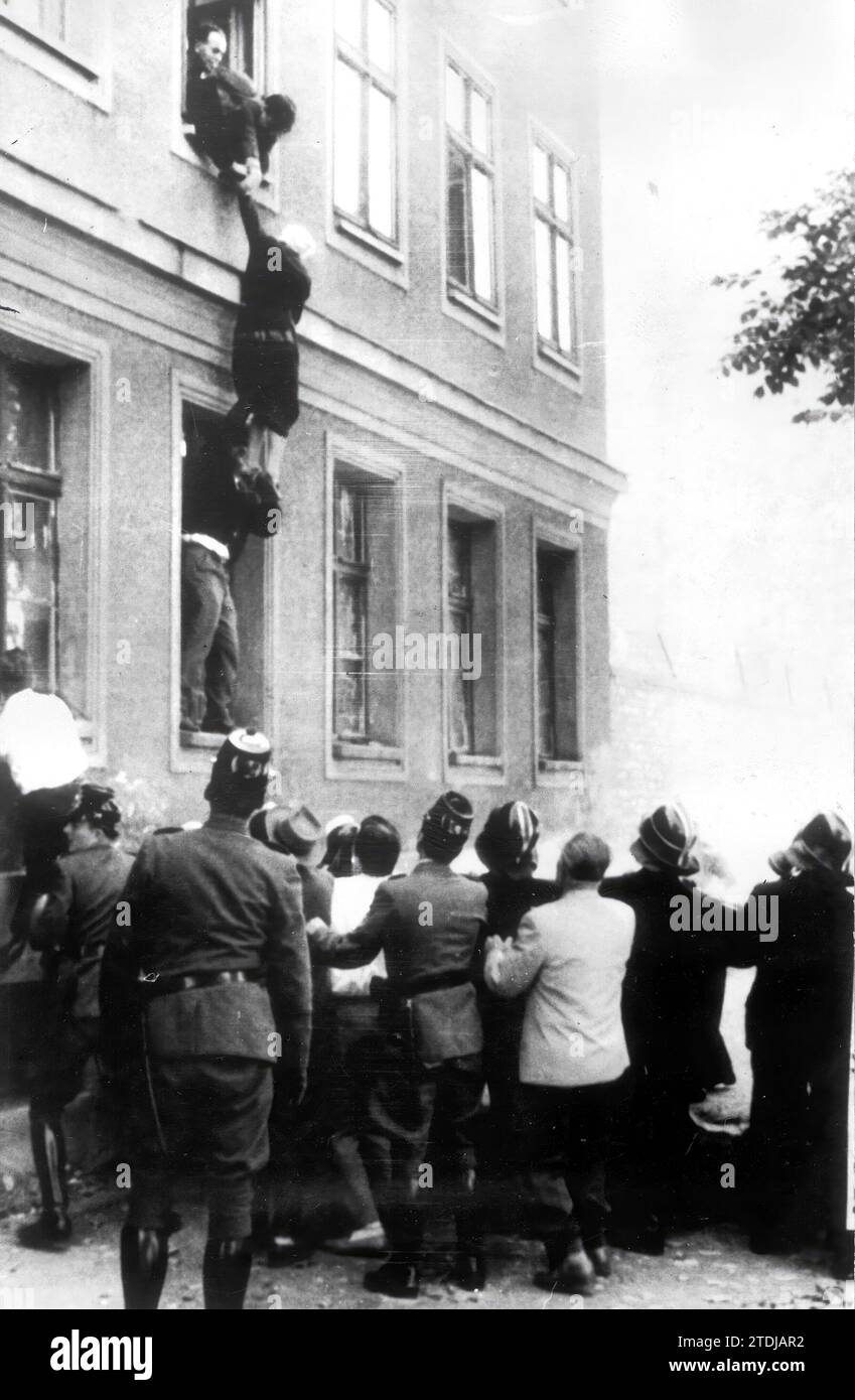 12/31/1960. Per fuggire dalla zona comunista, una donna di 77 anni viene aiutata a saltare, dal secondo piano di una casa la cui facciata posteriore si affaccia sulla zona occidentale, al telo tenuto dai vigili del fuoco e da altre persone. Crediti: Album / Archivo ABC Foto Stock