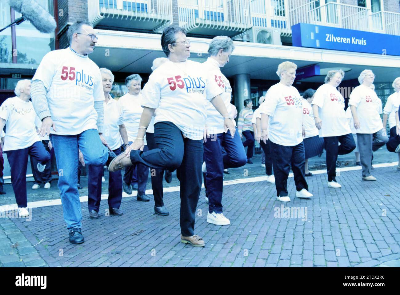 Fitness al Plein 1945 per oltre 55 persone con t-shirt "55plus in movimento" presso l'ufficio Zilveren Kruis, IJmuiden, Plein 1945, Paesi Bassi, 14-10-1997, Whizgle News dal passato, su misura per il futuro. Esplora le narrazioni storiche, l'immagine dell'agenzia olandese olandese con una prospettiva moderna, colmando il divario tra gli eventi di ieri e quelli di domani. Un viaggio senza tempo che delinea le storie che plasmano il nostro futuro Foto Stock