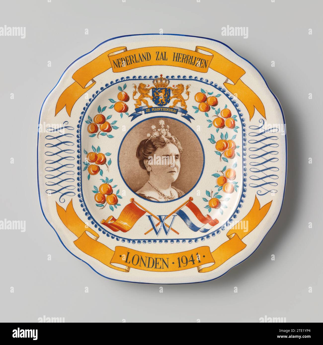 Piatto con ritratto di Wilhelmina, 1941 piatto con ritratto di Wilhelmina. Sul bordo del tabellone è indicato in due Oranje Banderols 'The Netherlands will rise /. Londen.1941.'. Centrale una foto rotonda di Wilhelmina. Nella parte posteriore è presente un filo metallico con copertura in plastica verde per appendere la piastra. Inghilterra. Piatto con ritratto di Wilhelmina. Sul bordo del tabellone è indicato in due Oranje Banderols 'The Netherlands will rise /. Londen.1941.'. Centrale una foto rotonda di Wilhelmina. Nella parte posteriore è presente un filo metallico con copertura in plastica verde per appendere la piastra. Inghilterra. Foto Stock