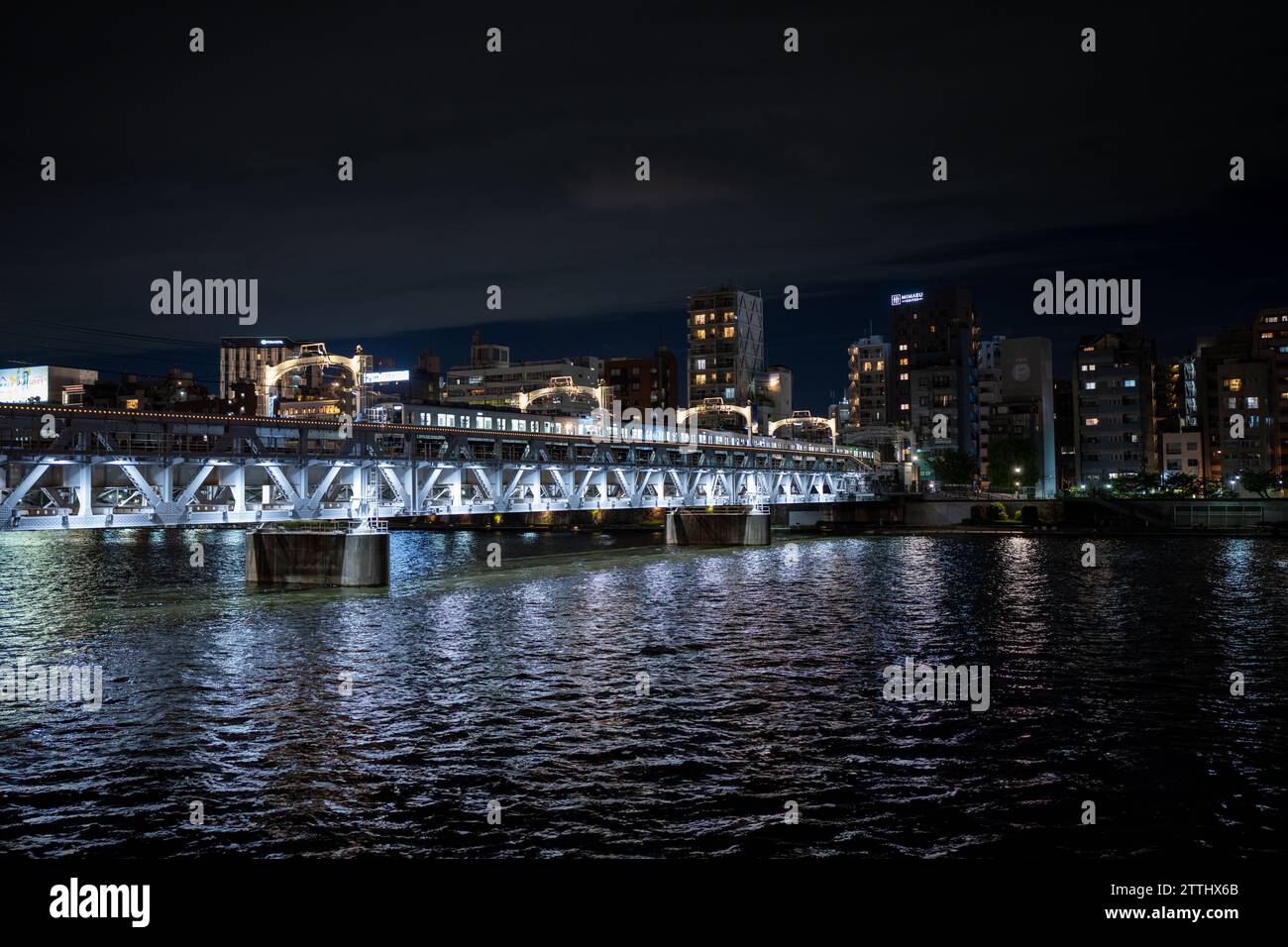 ponte ferroviario sul fiume sumida a tokyo in giappone di notte Foto Stock