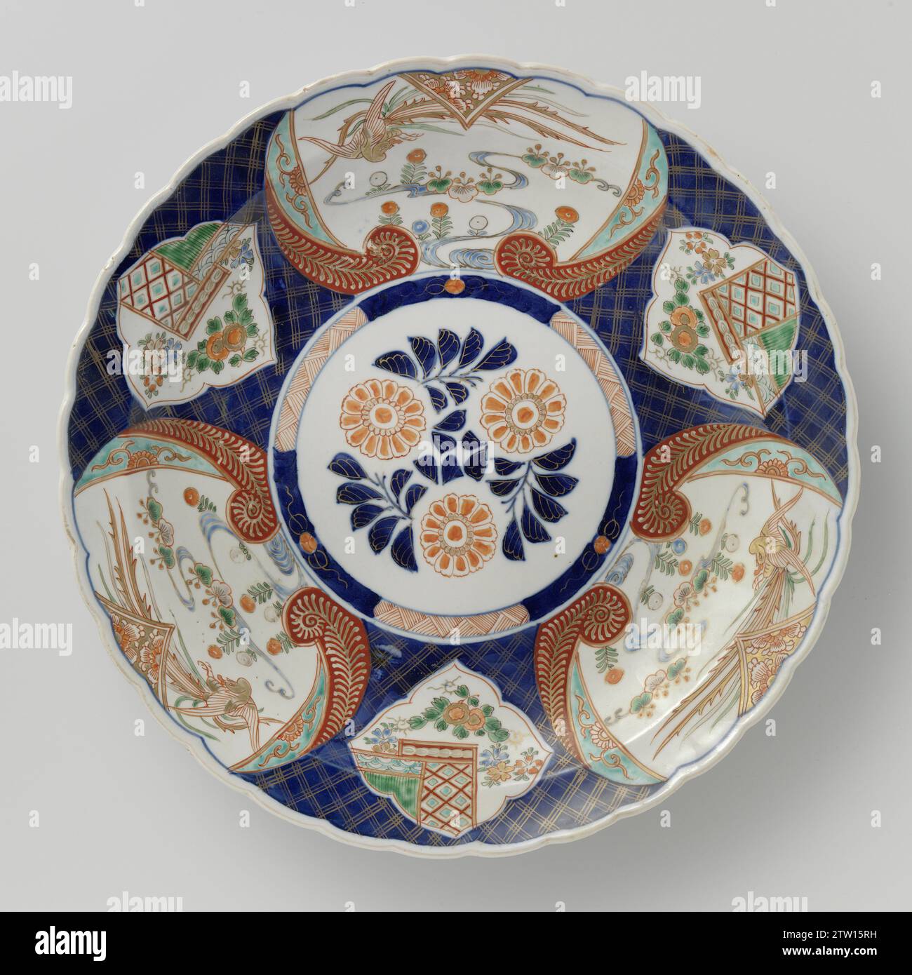 Piatto con uccellini e piante fiorite in pannelli su disegno pannolino, anonimo, c. 1700 - c. 1724 piattino in porcellana con bordo lobato, dipinto in blu trasparente e su blu glassa, rosso, verde, turchese, nero e oro. Sull'appartamento un medaglione con tre rami di fiori stilizzati; al medaglione un servetwork di pneumatici intervallato da un rango. La parete e il bordo con servetwork su uno sfondo di blu trasparente. Variava alternativamente tre grandi cartigli con un uccello Hoo volante sopra piante da fiore e tre cartilli smerlati con piante da fiore. Quattro volte gli oggetti di valore (pietra musicale, Foto Stock