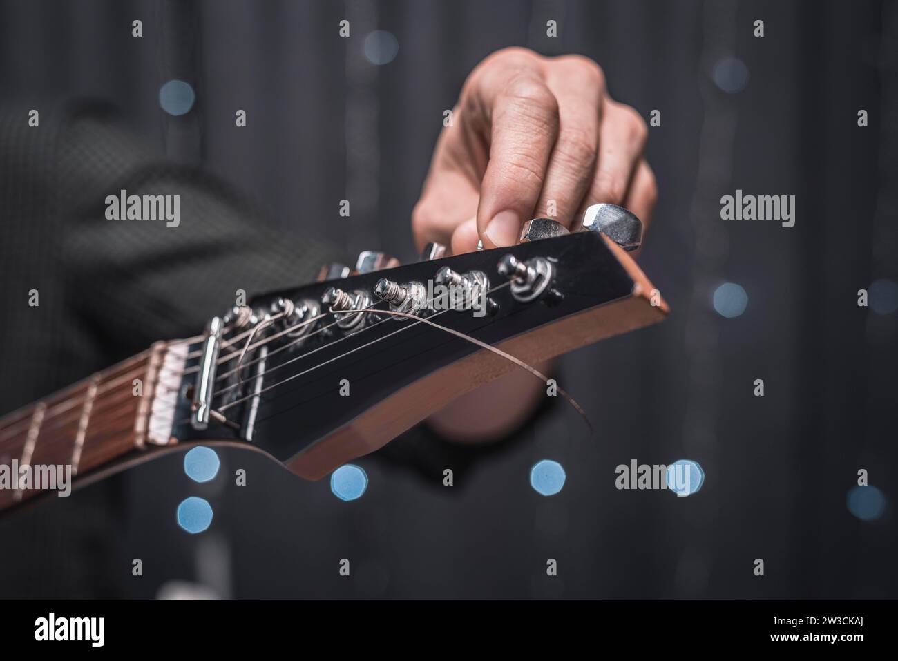 Immagine delle corde di una chitarra elettrica in primo piano. Il concetto di sintonizzazione e riparazione di strumenti musicali. Supporti misti Foto Stock