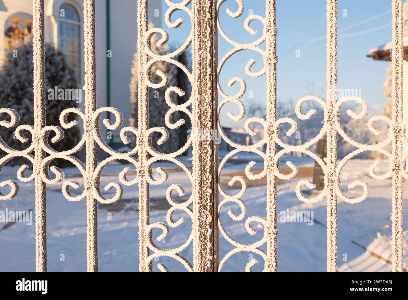 Immagine di una recinzione innevata. Concetto fiabesco invernale Foto Stock