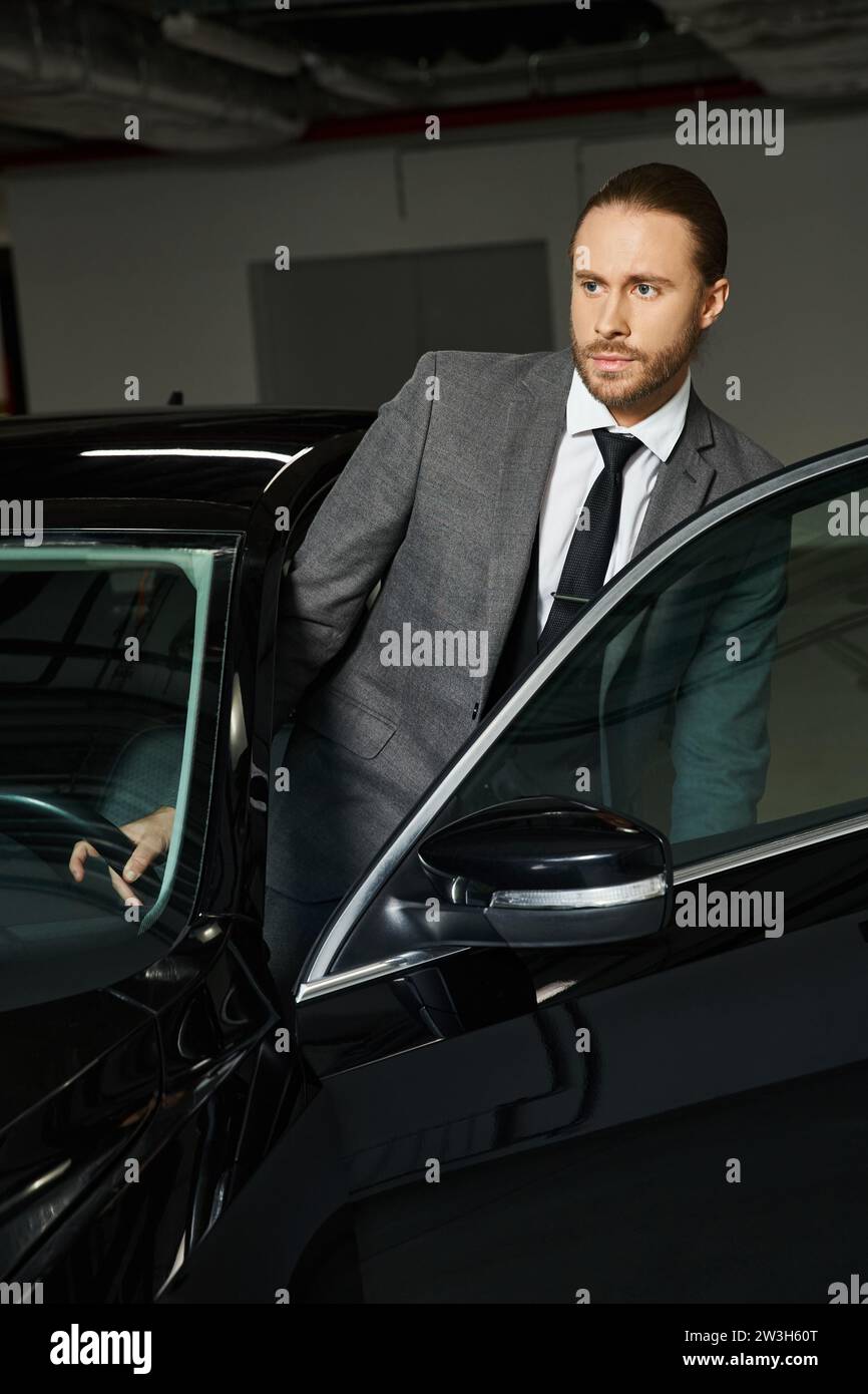 bell'aspetto professionale con un elegante vestito elegante che entra nella sua auto nel parcheggio, lavoro Foto Stock