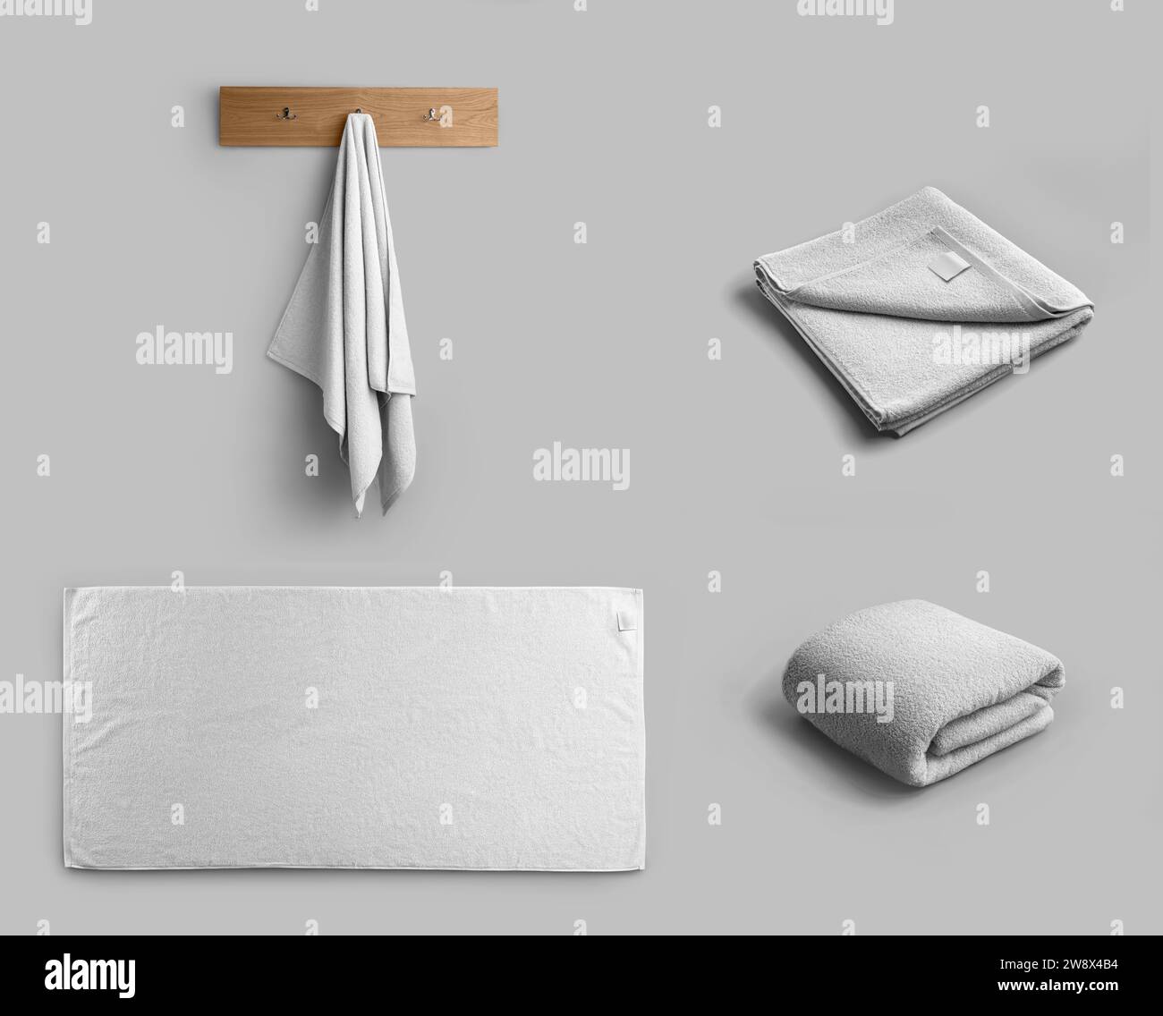 Mockup di un asciugamano bianco, disposto orizzontalmente, appeso a un appendiabiti, salvietta ripiegata per il marchio. Set di salviette da bagno morbide isolate sullo sfondo. Foto Stock