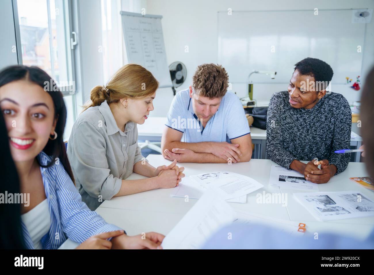 Amici multietnici che studiano insieme alla scrivania in un corso di formazione Foto Stock