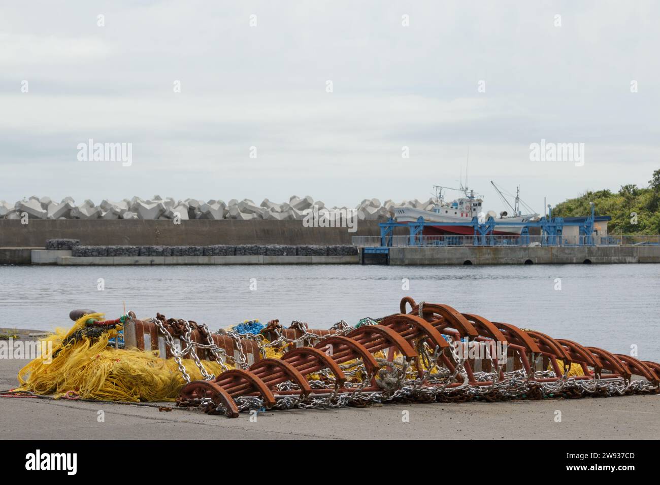 Corda da pesca e rete da traino metallica sul molo del porto Foto Stock