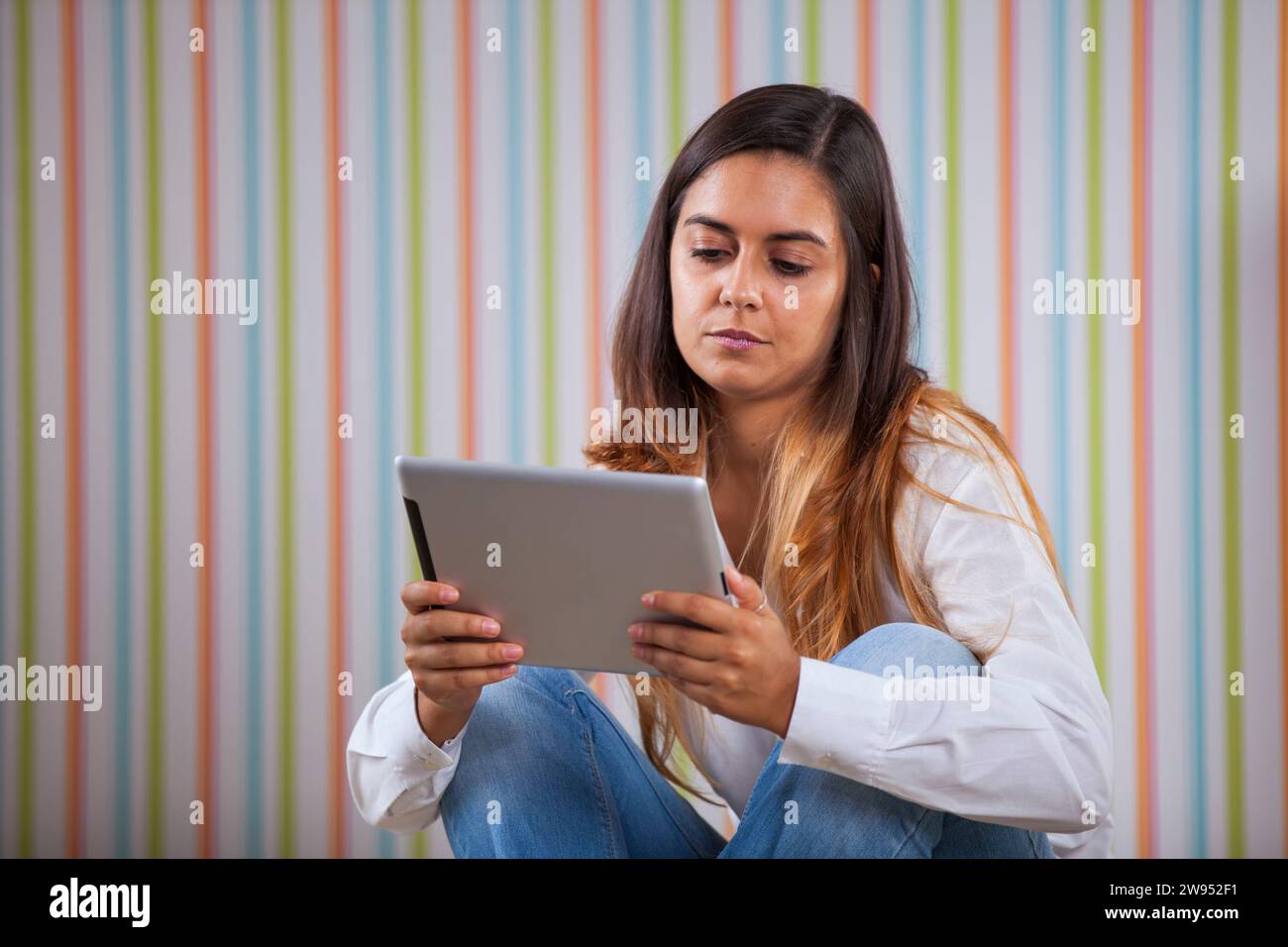 Giovane donna utilizzando una tavoletta digitale Foto Stock