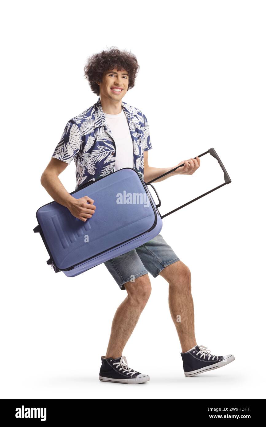 Un giovane felice che finge di suonare una chitarra con una valigia isolata su fondo bianco Foto Stock